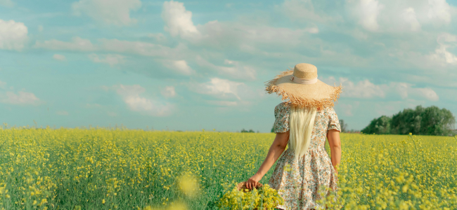 Femme dans un champ de fleurs jaunes en été