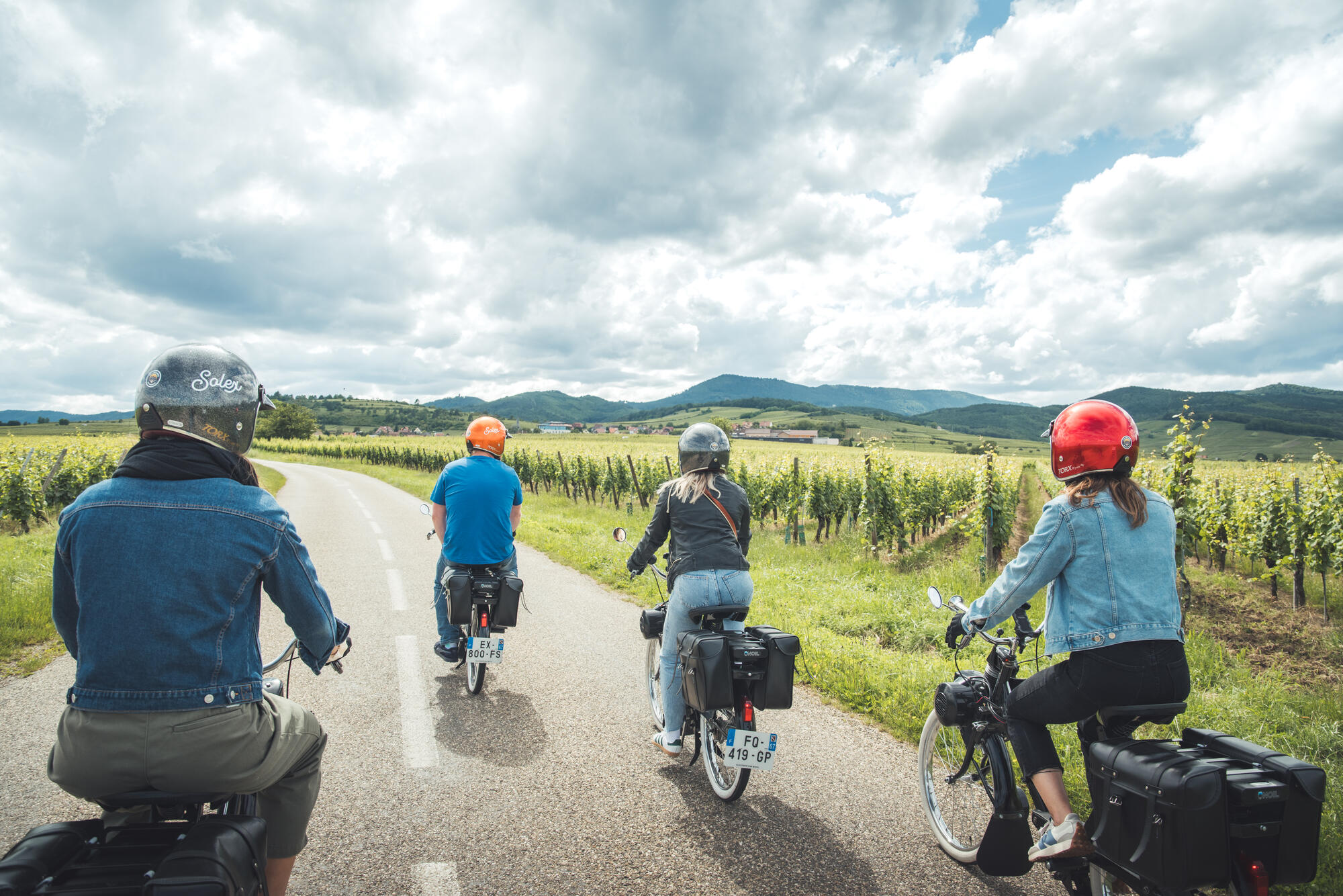 Groupe de motards parcourant une route dans les vignes